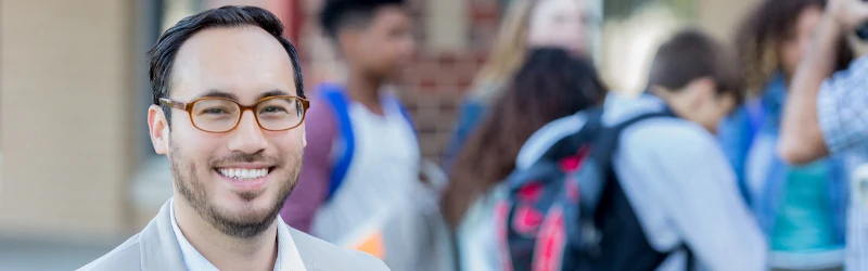 Photo of high school principal with students in the background