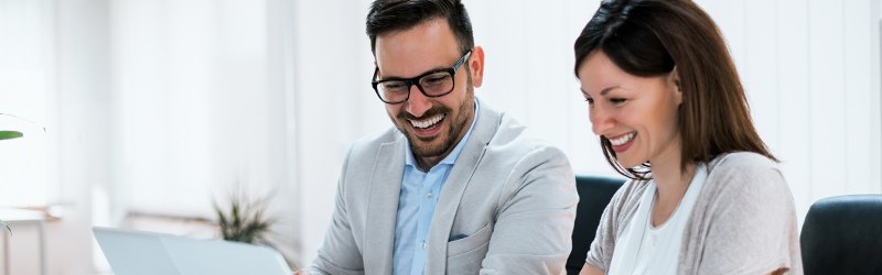 Two educational administrators reviewing materials on a computer